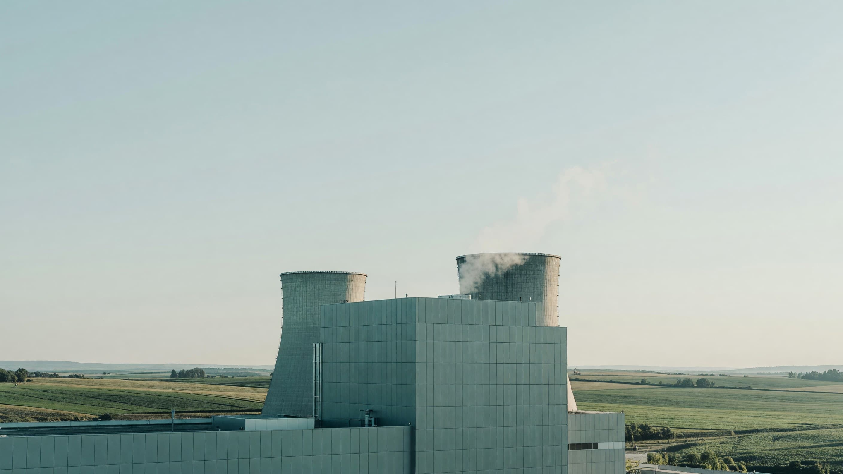 The Mochovce plant's cooling towers rise behind unit 4's completed reactor building — Slovakia's fourth VVER-440 moves into physical start-up tests. Illustration: NNN