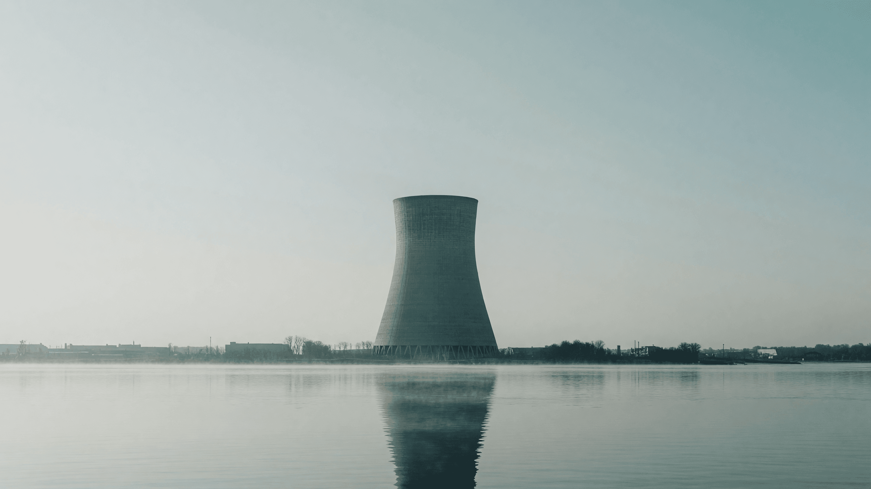 A natural-draft cooling tower rises over the Delaware River in morning haze — New Jersey's 1,100 MW nuclear procurement. Illustration: NNN