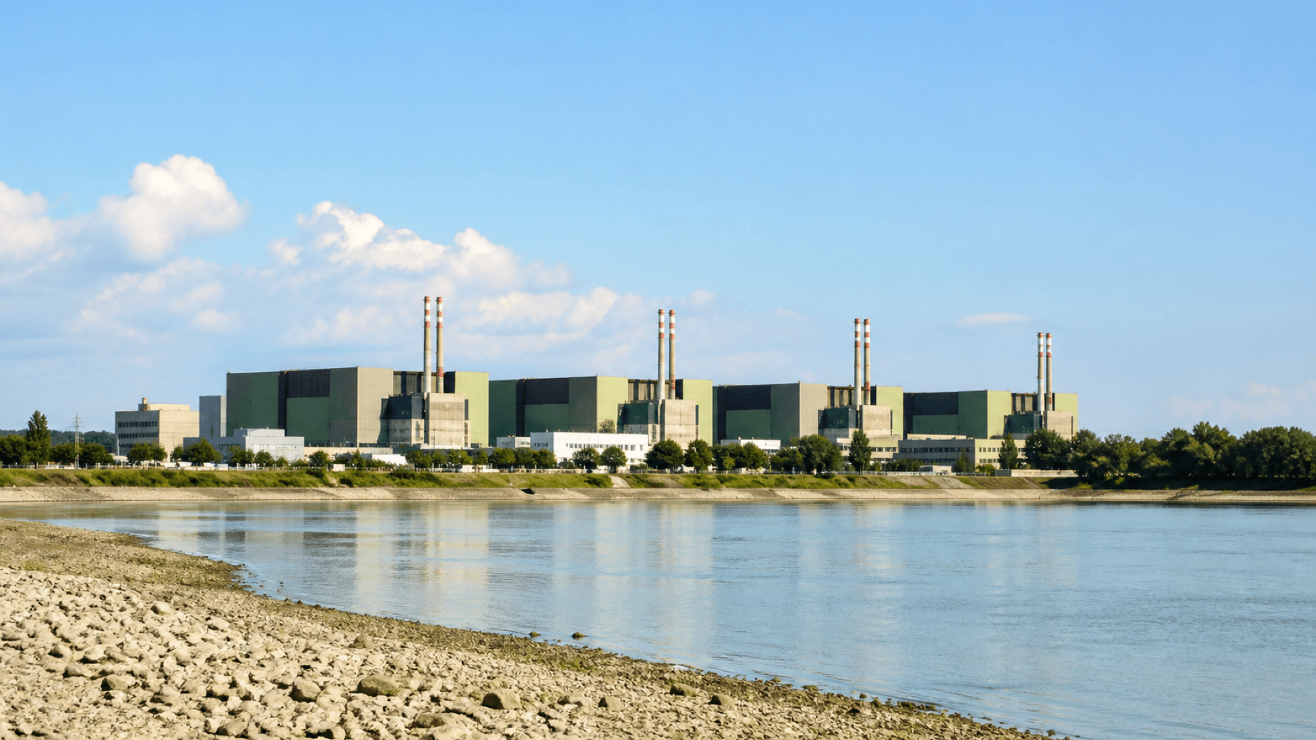 The Paks nuclear power station beside the Danube as Units 1 and 3 return to nominal power after low river levels constrained cooling water. Illustration: NNN