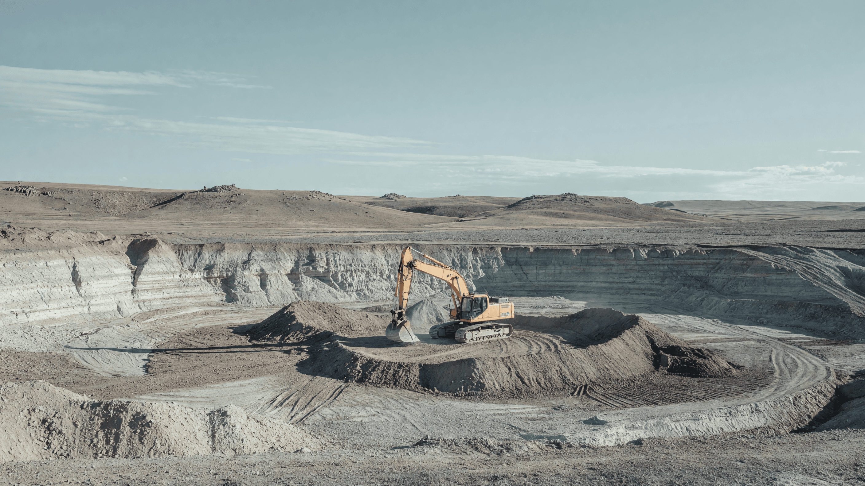 A lone excavator digs the Natrium unit 1 pit on Wyoming's high plains — TerraPower's Kemmerer excavation begins. Illustration: NNN