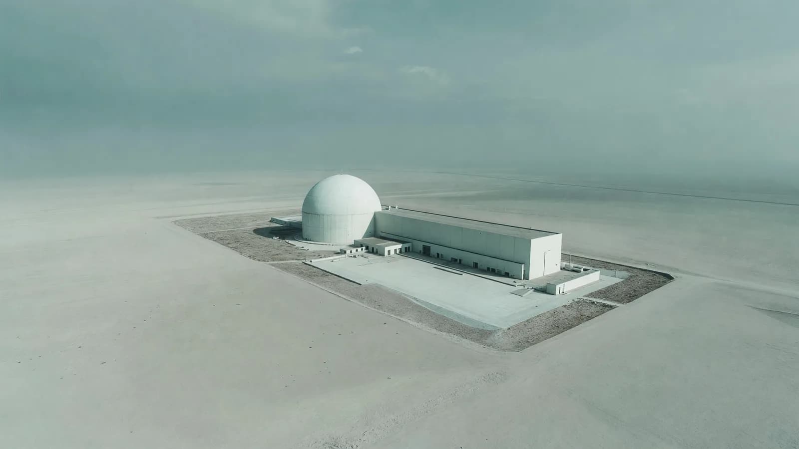 Aerial view of a containment dome and turbine hall — the NRC's AP1000 exemption decision leads today's brief. Illustration: NNN