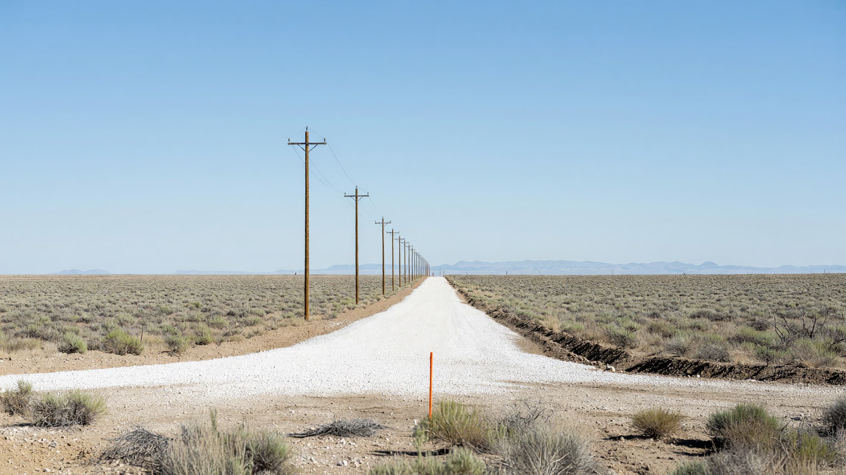 A freshly graded parcel with a new gravel road and utility poles on Idaho National Laboratory's roughly 2,000-acre Nuclear Energy Launch Pad site, where six of the 13 newly selected projects are headed. Illustration: NNN