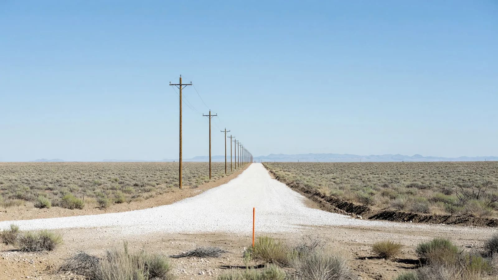 A freshly graded parcel with a new gravel road and utility poles on Idaho National Laboratory's roughly 2,000-acre Nuclear Energy Launch Pad site, where six of the 13 newly selected projects are headed. Illustration: NNN