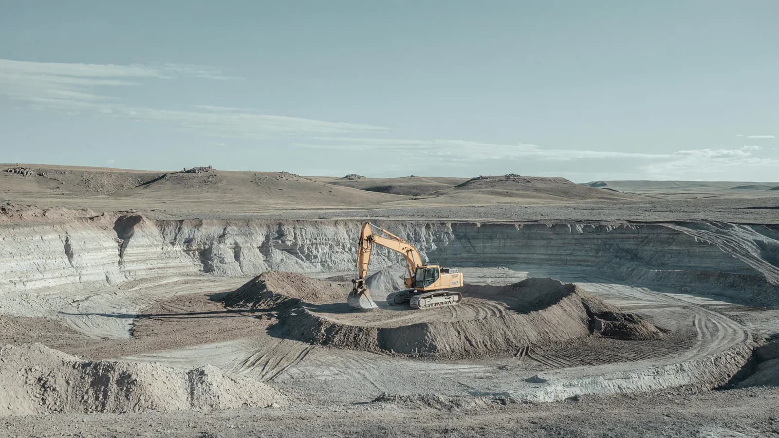 A lone excavator digs the Natrium unit 1 pit on Wyoming's high plains — TerraPower's Kemmerer excavation begins. Illustration: NNN